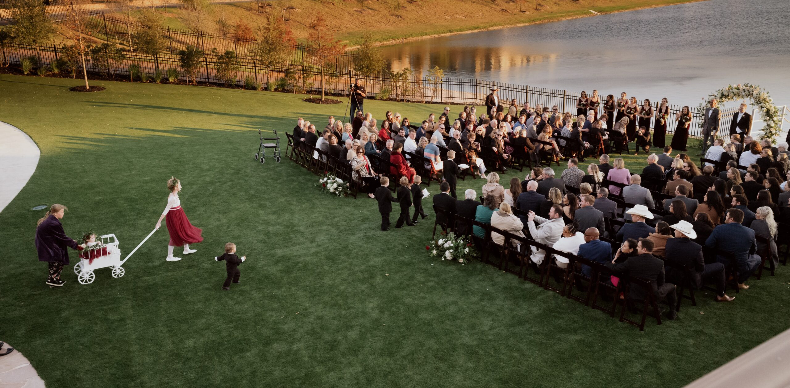 Outdoor wedding ceremony with guests by the lake
